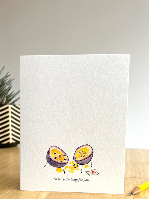 Greeting card with illustration of two passion fruits on a wooden surface.