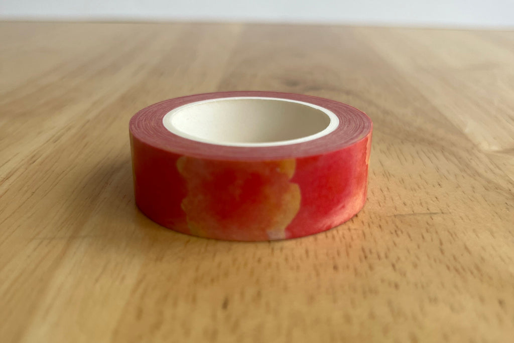 Red tape washi roll on a wooden surface