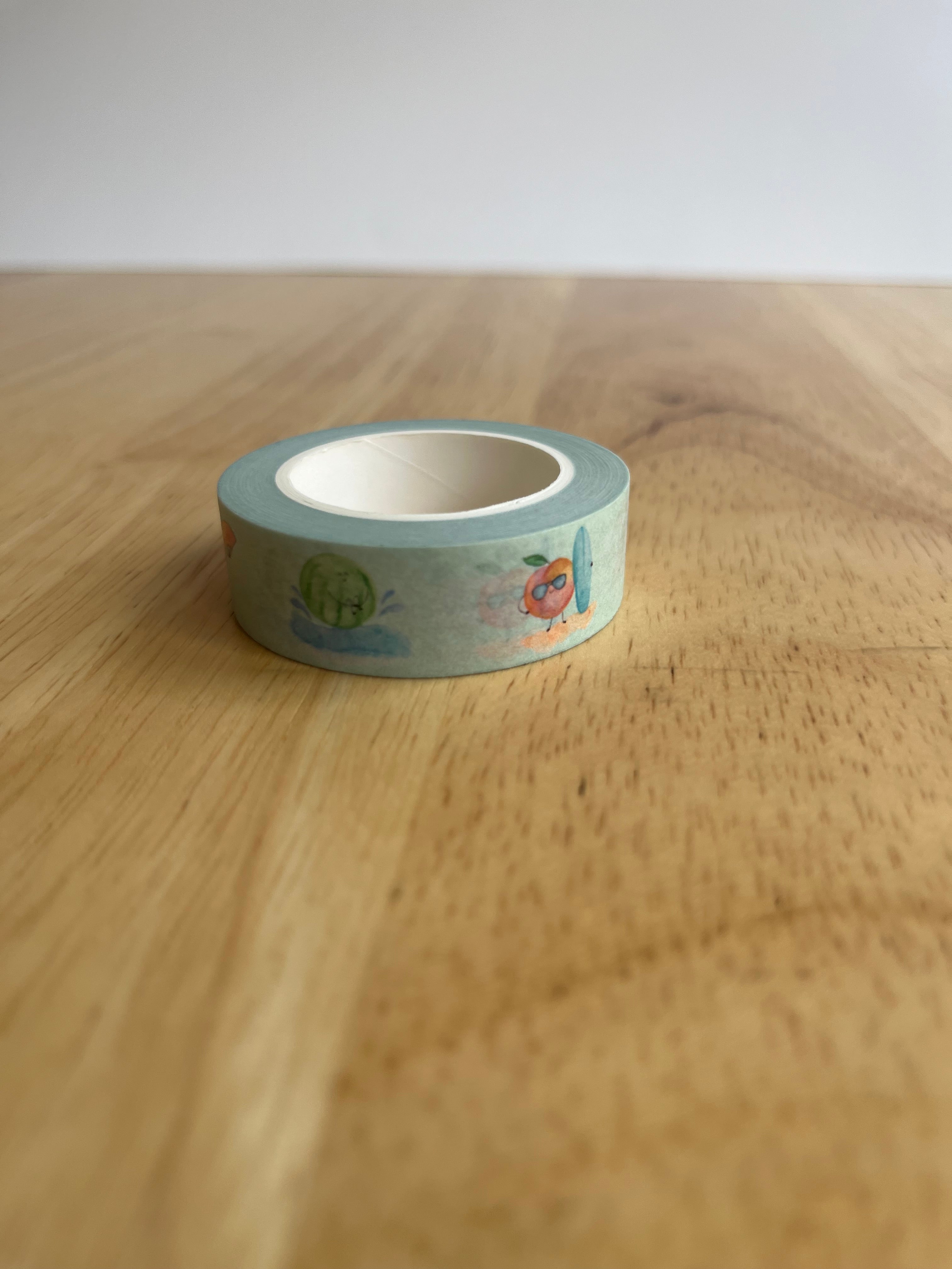 Roll of decorative tape with cartoon designs on a wooden surface