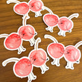 pile of Die-cut vinyl stickers of cherries kissing. I cherry-ish you