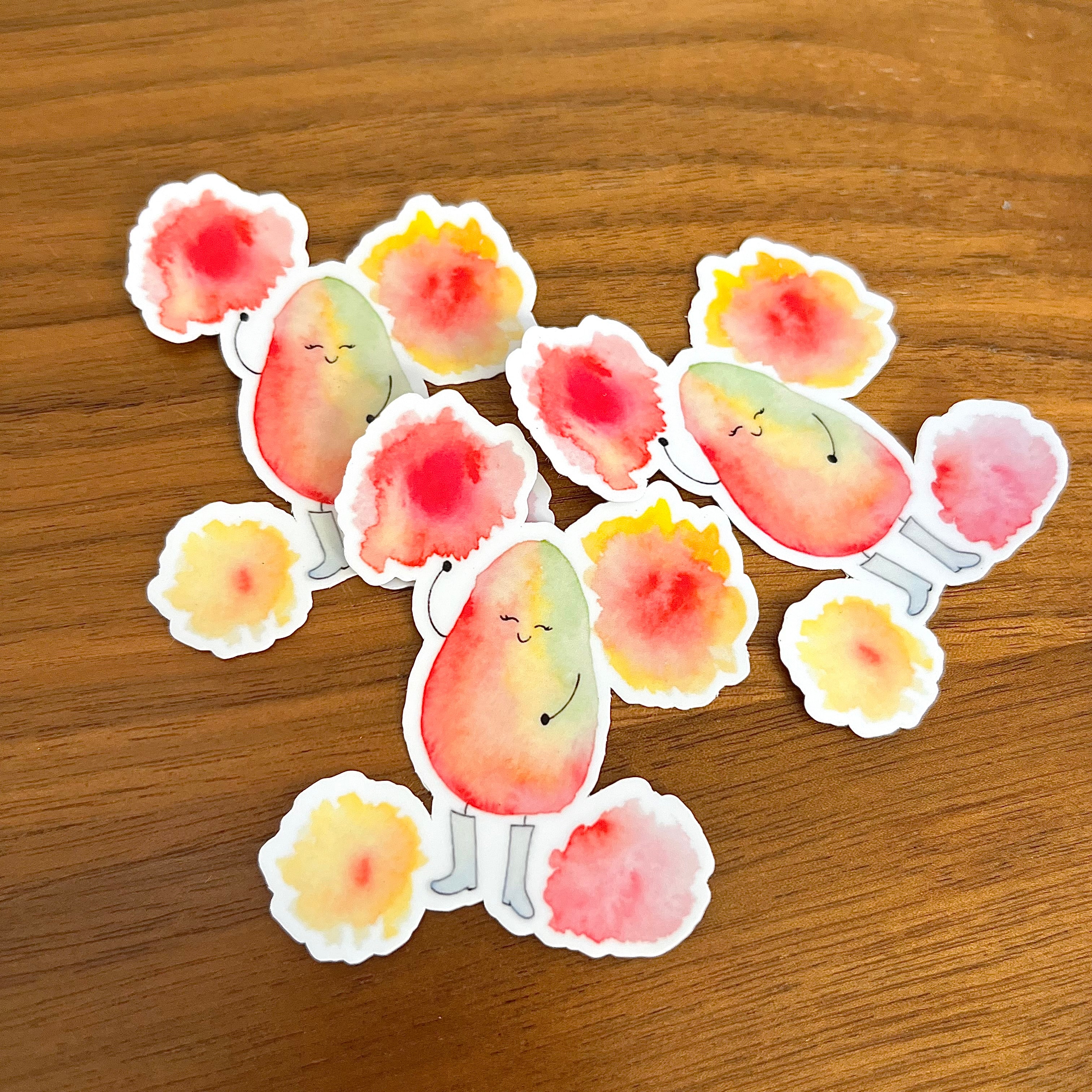 A set of cute avocado-shaped stickers with smiling faces and small arms and legs, arranged on a brown wooden surface