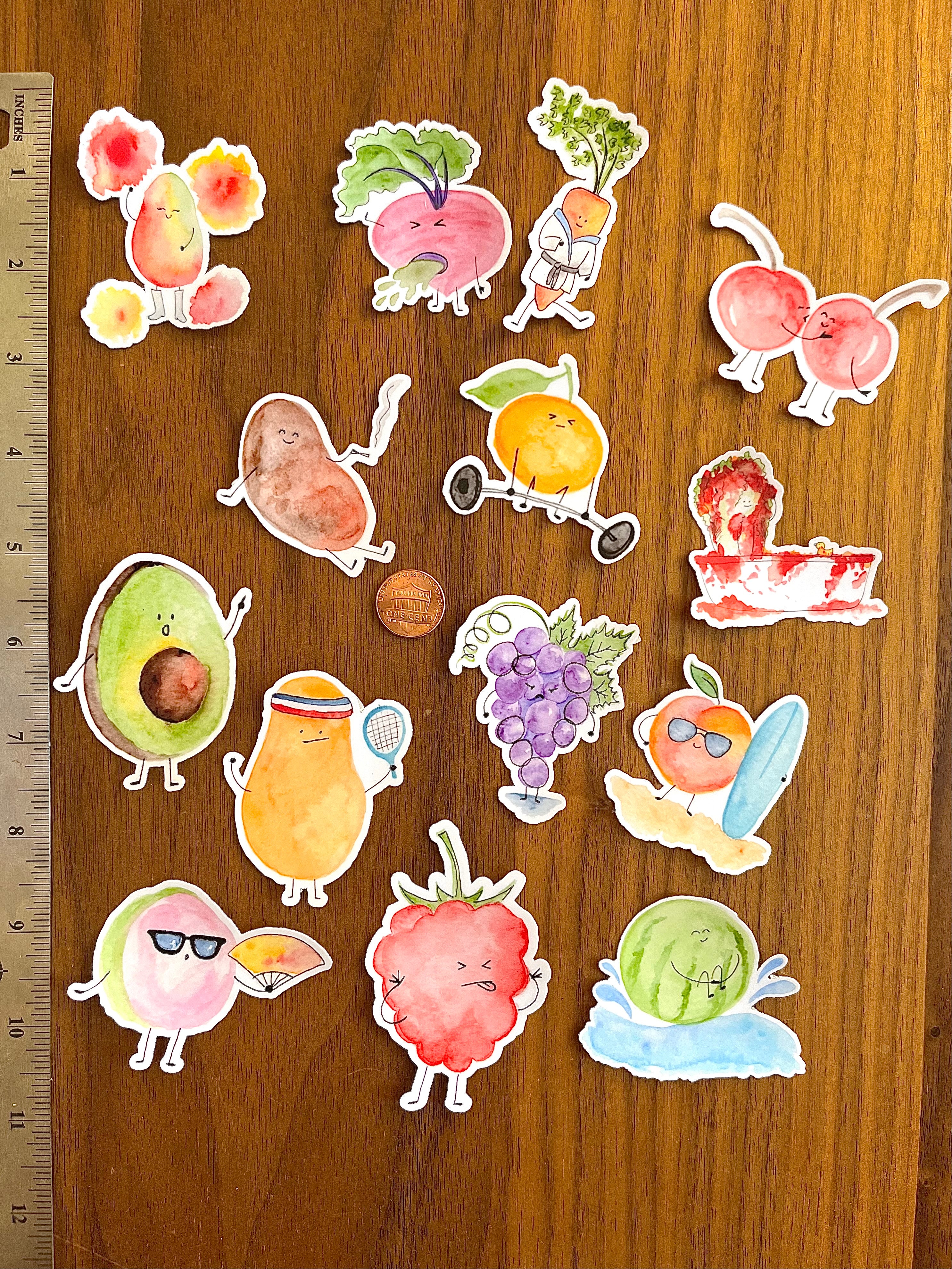 All Mei Pie Studio Die-cut vinyl stickers next to a measuring stick. all stickers 2" widest