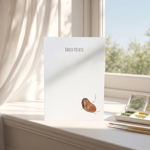 Greeting Card with a baked potato illustration on a windowsill with art supplies.