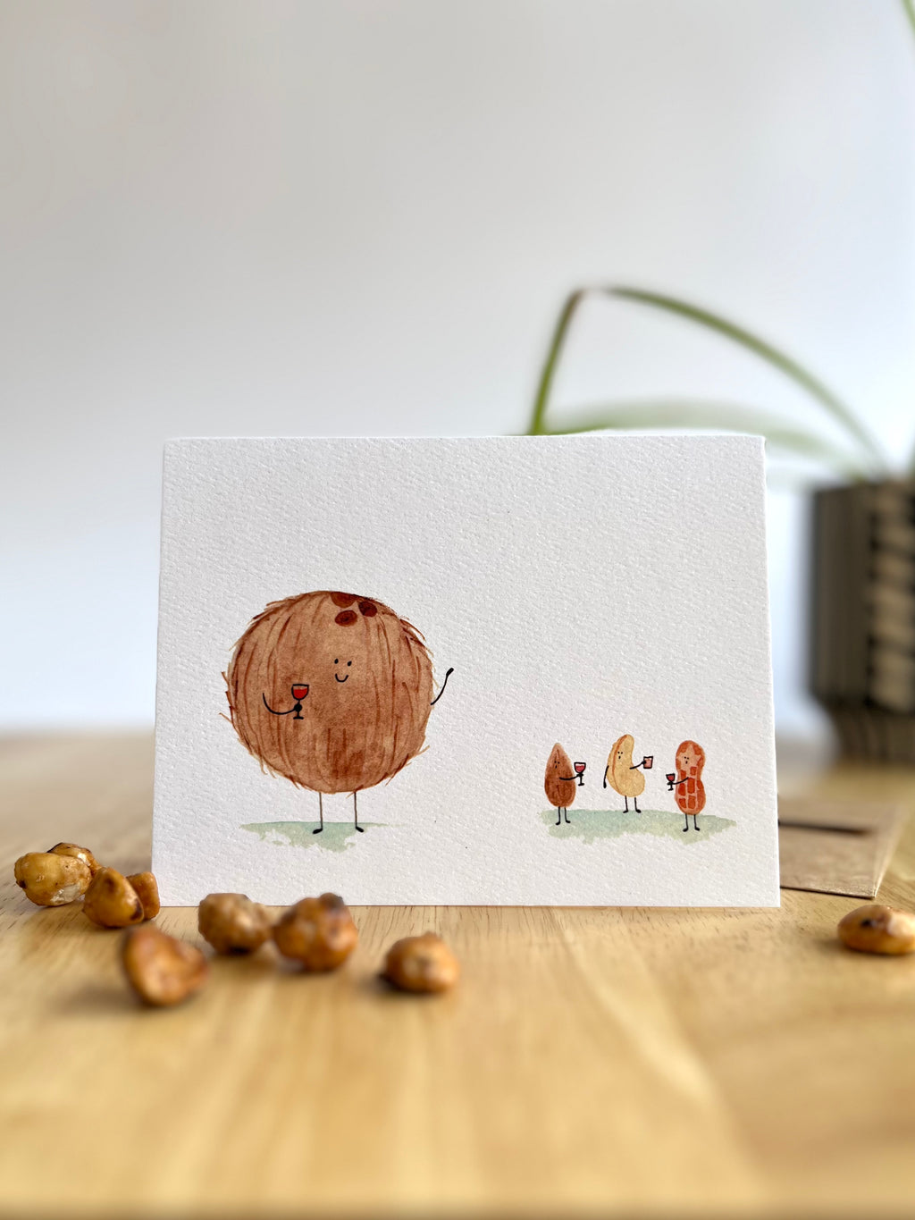 Feel like an Awkward Nut? This funny social anxiety card features a giant watercolor coconut waving to small nuts. Relatable, cute, and perfect for friends.