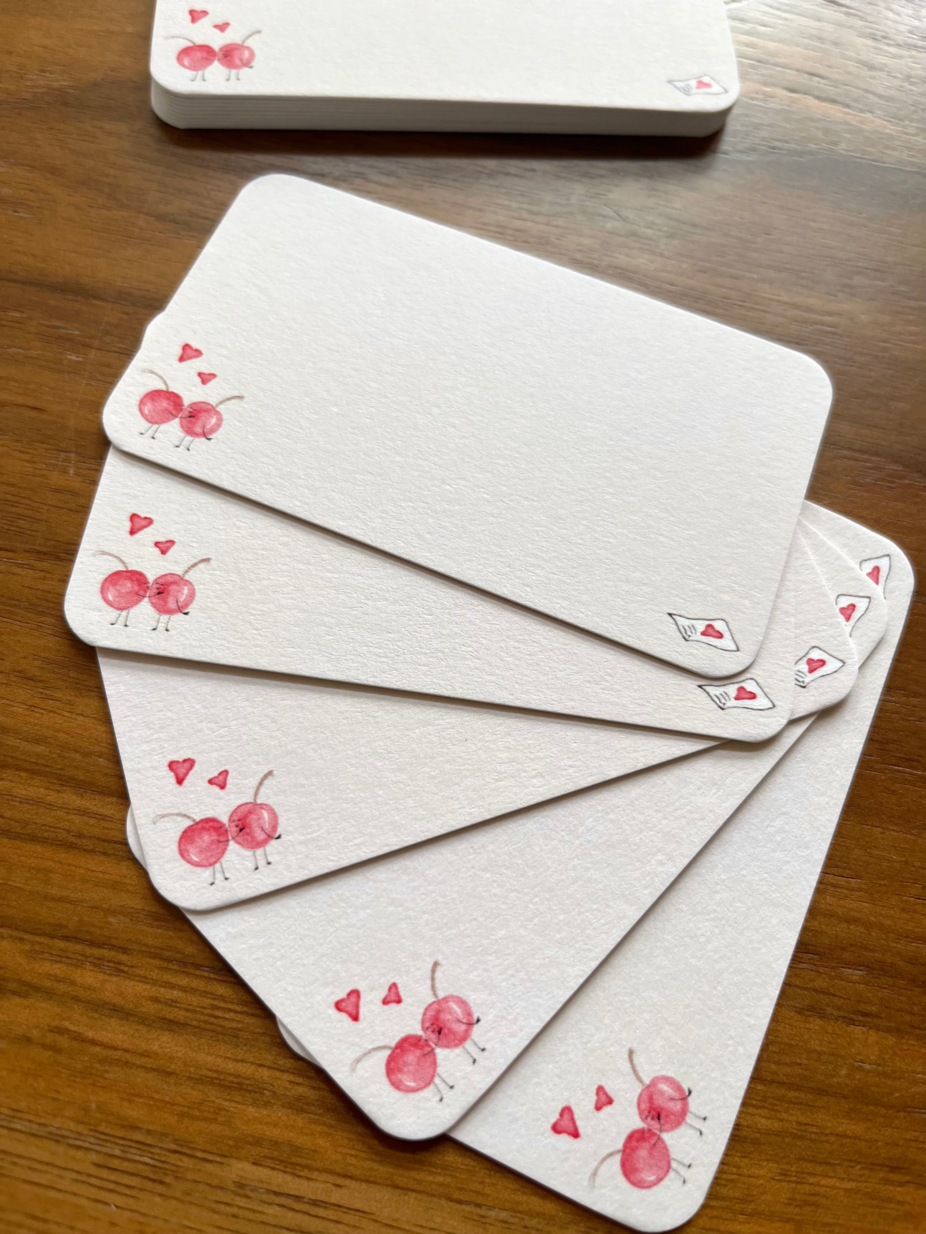 mei pie studio pink cherry love notes mini note set on classic crest neenah stock. close up on a wooden table