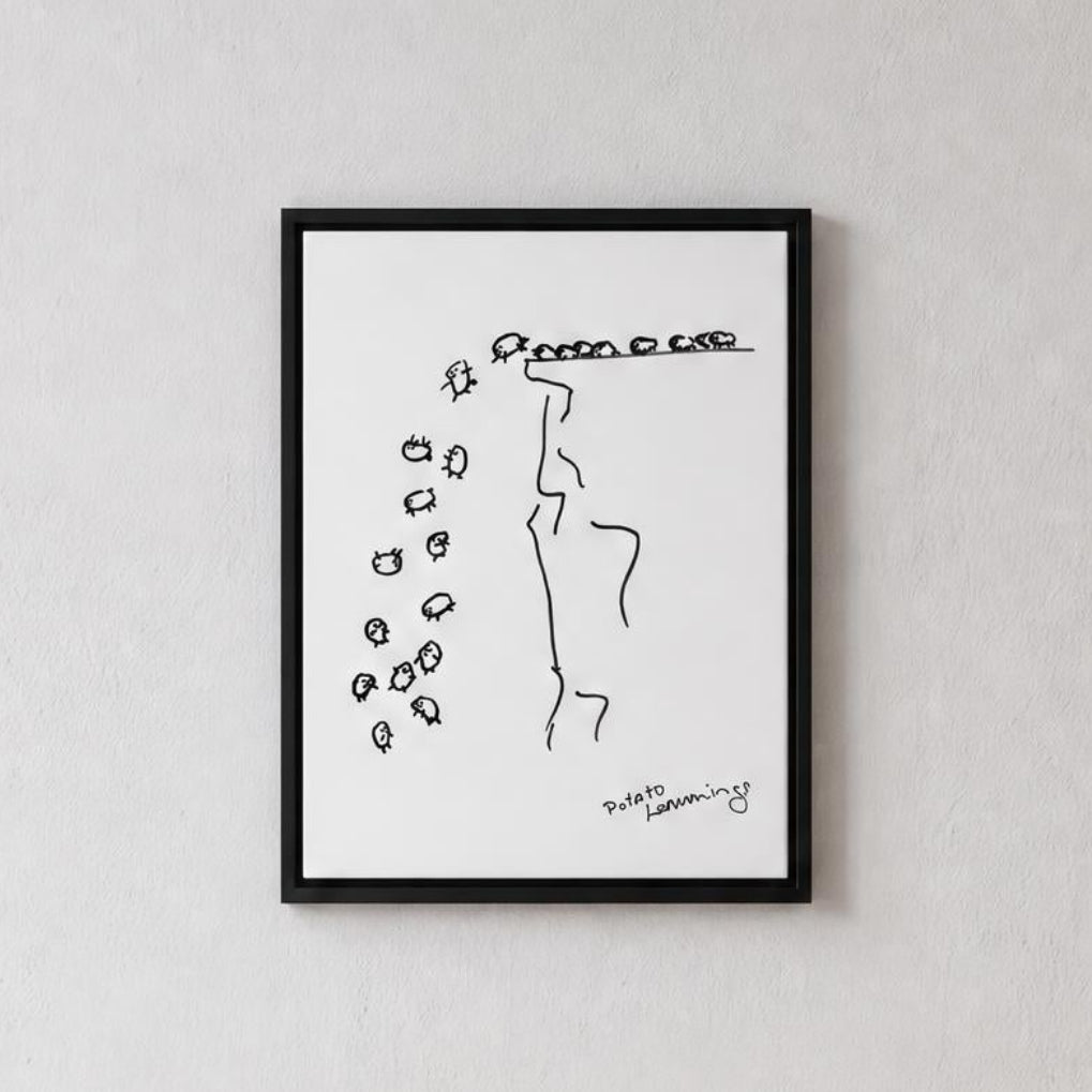 A minimalist black and white art print with a thin black frame, hanging on a textured light gray wall above a light wood console table with a ceramic vase.